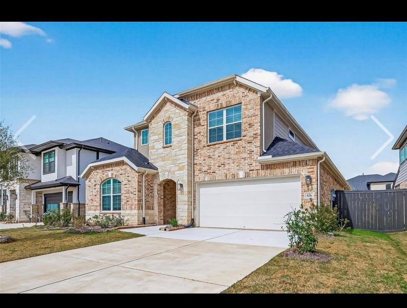 Front exterior of a new home in Harvest Green, Richmond, TX, highlighting curb appeal (Image 2).
