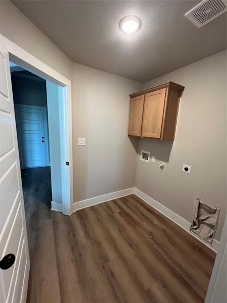 Laundry room featuring hookup for an electric dryer, dark wood-style flooring, baseboards, visible vents, and hookup for a washing machine