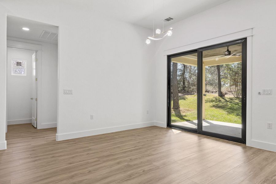 Unfurnished dining area featuring light wood-type flooring, a ceiling fan, and recessed lighting