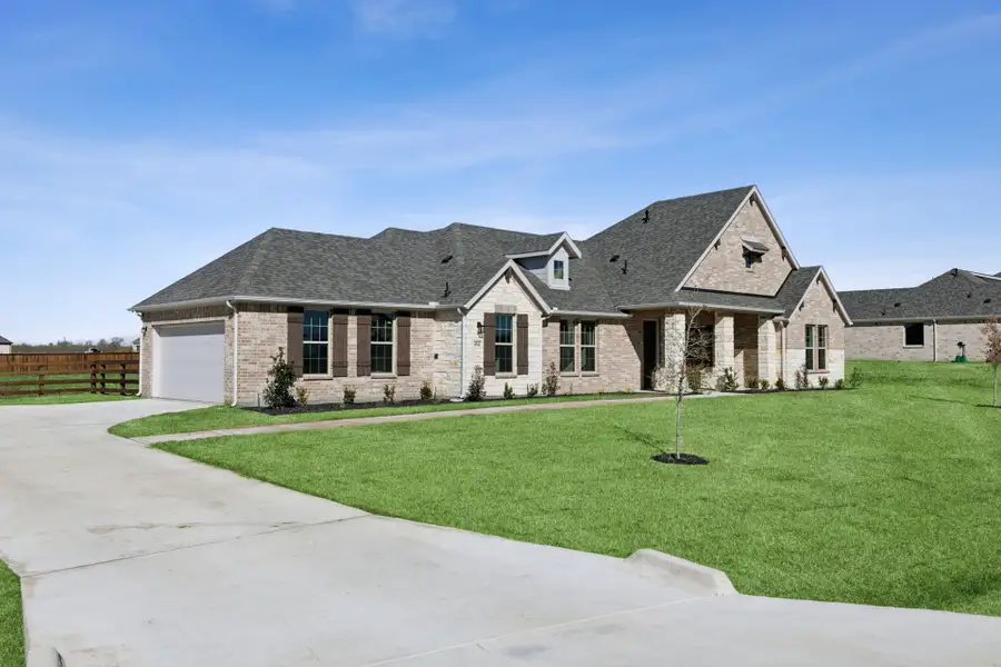 Front exterior of a new home in Ellis Ranch Estates, Waxahachie, TX, highlighting curb appeal (Image 1). Front exterior of a new home in Ellis Ranch Estates, Waxahachie, TX, highlighting curb appeal (Image 1).