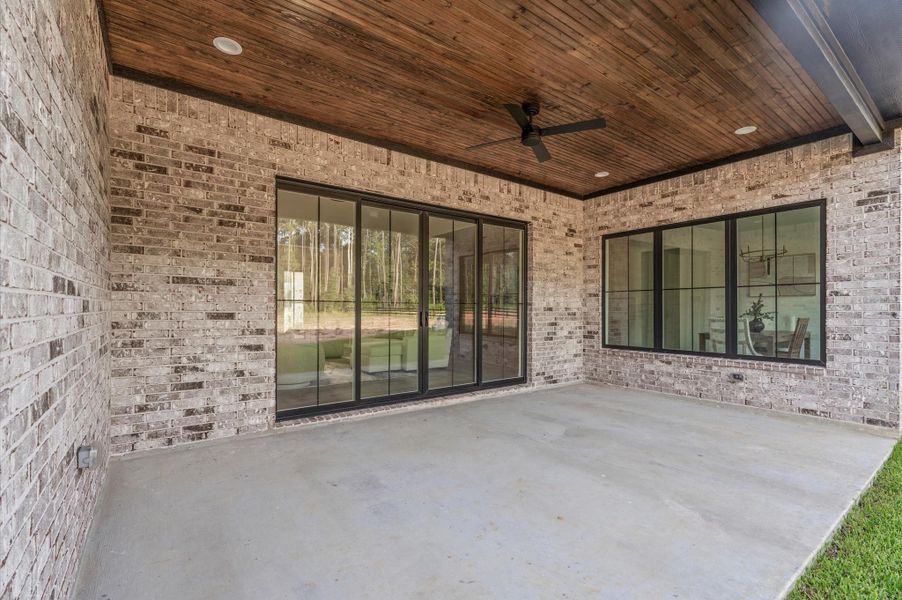 Extended covered patio with wood-accented ceiling and LED lighting — perfect for outdoor entertaining.Enjoy peaceful evenings or weekend cookouts surrounded by nature and privacy. Extended covered patio with wood-accented ceiling and LED lighting — perfect for outdoor entertaining.Enjoy peaceful evenings or weekend cookouts surrounded by nature and privacy.