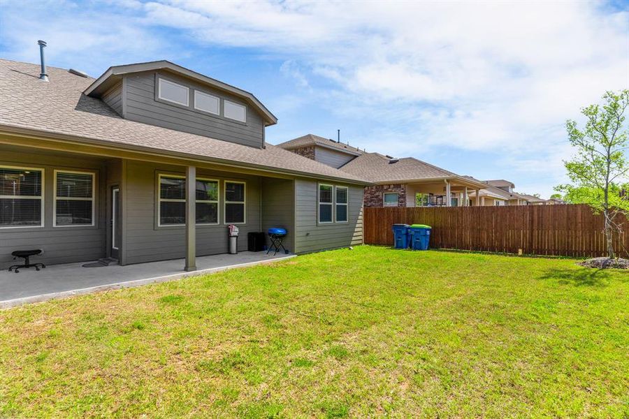 View of yard with fence and a patio area