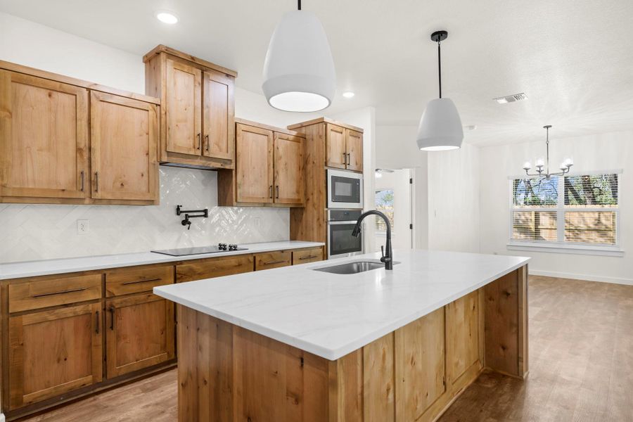 A well-appointed kitchen showcasing an island and integrated appliances, perfect for culinary endeavors.