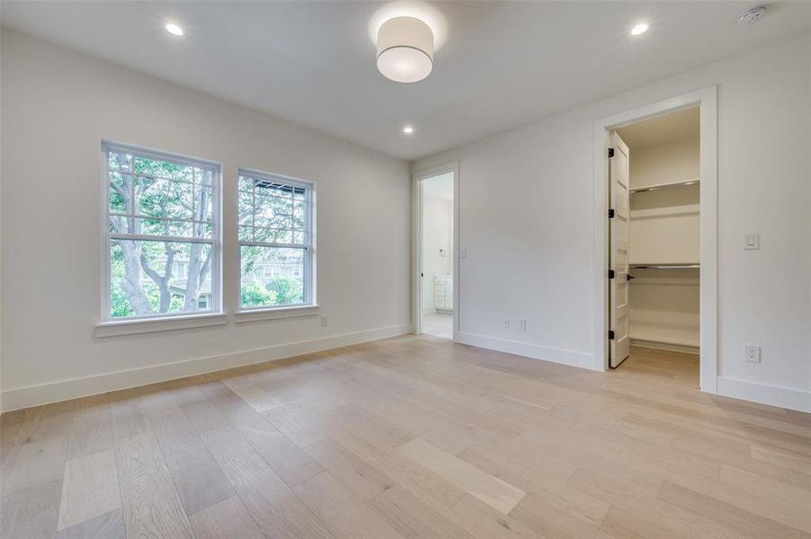 Empty room with light hardwood / wood-style floors