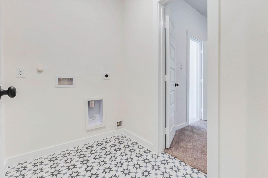 Interior utility room with washer and dryer connections.
