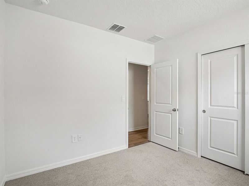 Spacious, unfurnished interior of a new home in The Grove at Stuart Crossing - Premier Series, Bartow (Image 19).