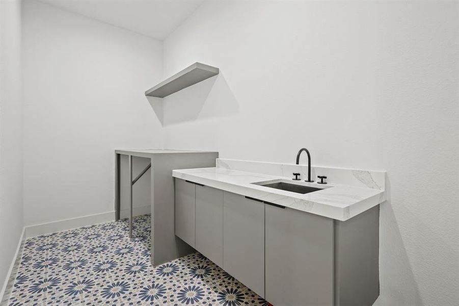 Bathroom with tile patterned flooring and sink