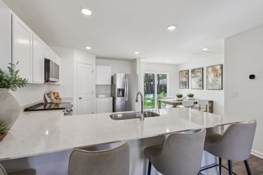 A kitchen with a dining table and chairs. A kitchen with a dining table and chairs.