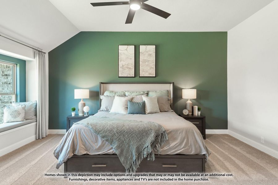 Bedroom with vaulted ceiling, green accent wall, ceiling fan, window seat, and storage bed on carpet Bedroom with vaulted ceiling, green accent wall, ceiling fan, window seat, and storage bed on carpet