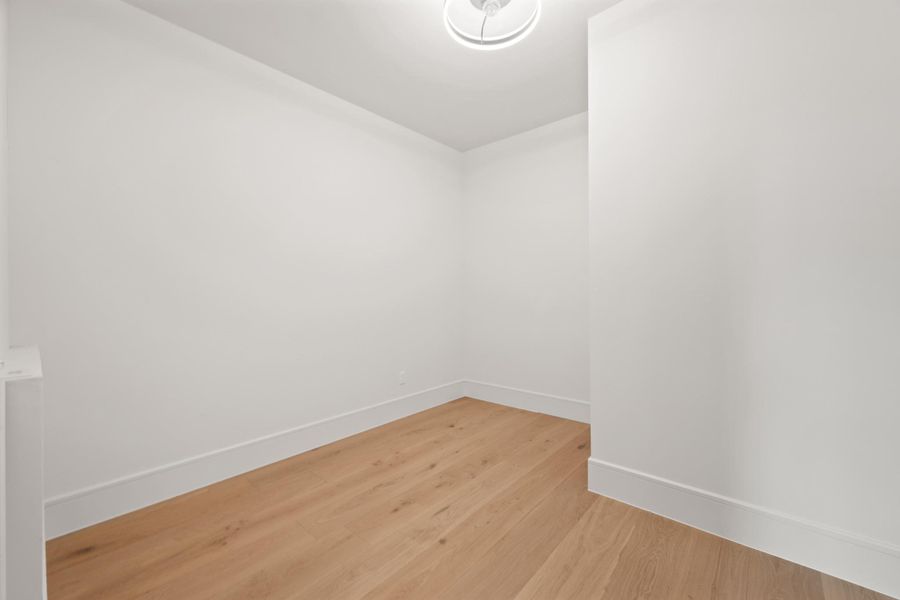 Smooth plaster walls and wide-plank wood flooring define this versatile interior space.