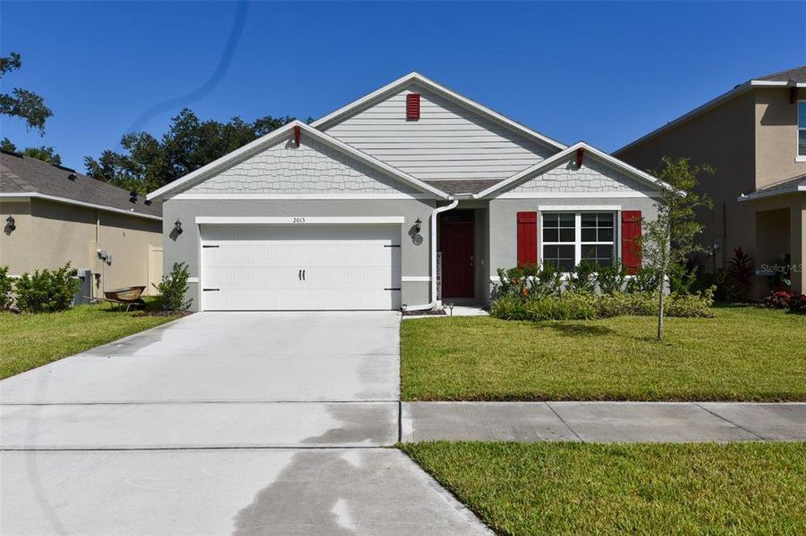 Front exterior of a new home in Oak Leaf Preserve, New Smyrna Beach, FL, highlighting curb appeal (Image 1). Front exterior of a new home in Oak Leaf Preserve, New Smyrna Beach, FL, highlighting curb appeal (Image 1).