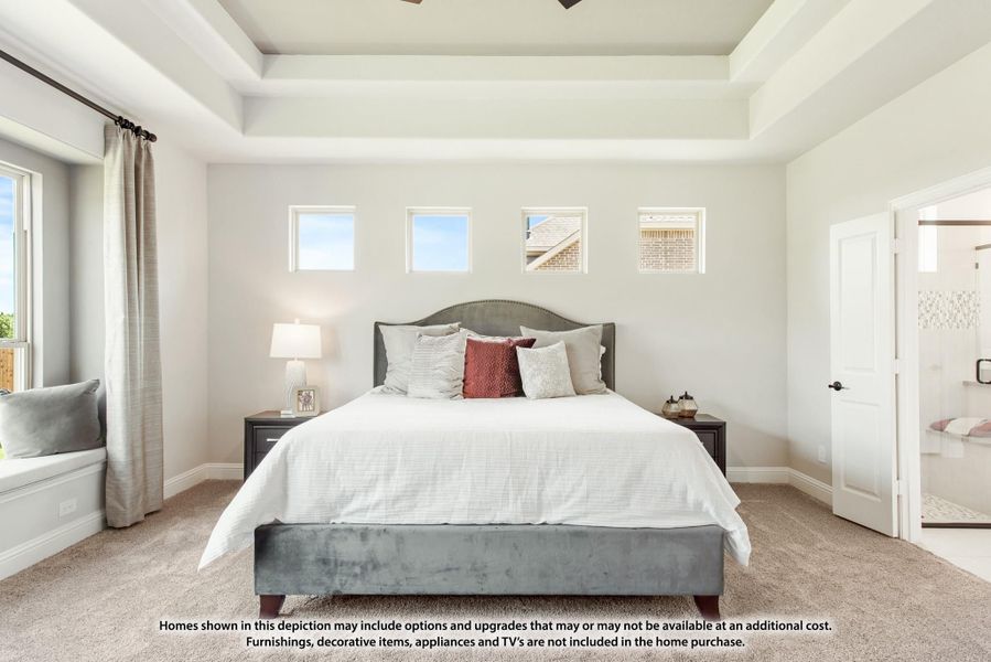 Master bedroom with tray ceiling, carpet flooring, window seat, and ensuite bathroom access