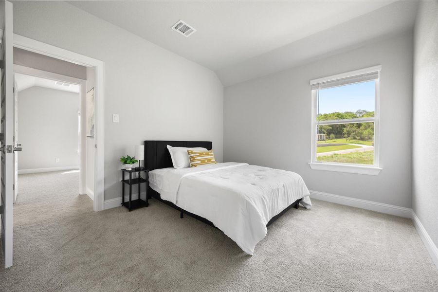 Spacious secondary bedroom located on 2nd floor with carpet, high ceilings, ceiling fan, and walk in closet