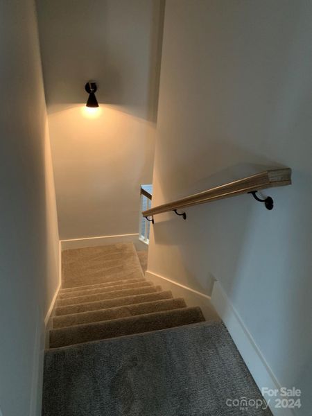 View from doorway of bonus room looking down split staircase