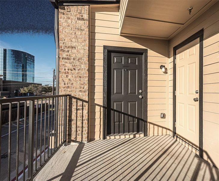 View of exterior entry featuring a balcony