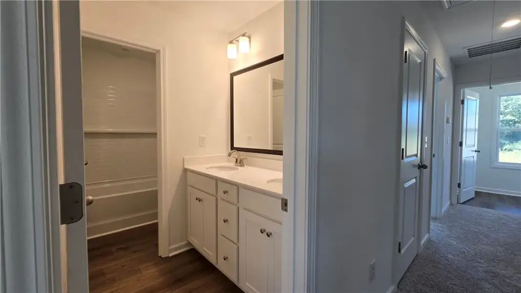A classic dual vanity bathroom seamlessly transiti