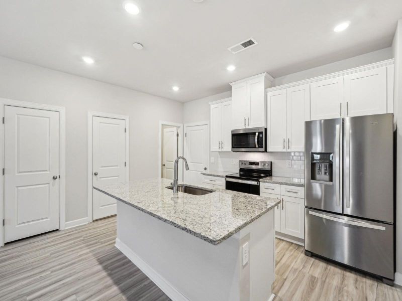 The spacious kitchen and oversized island makes cooking much more enjoyable.