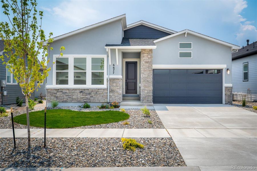 Front exterior of a new home in Wolf Ranch - Enclave Collection, Colorado Springs, CO, highlighting curb appeal (Image 1).