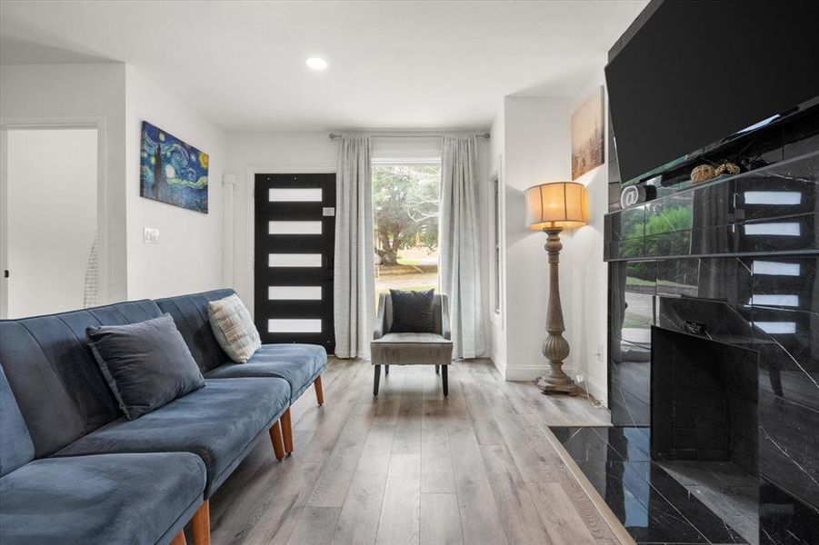 Living area featuring wood finished floors and recessed lighting Living area featuring wood finished floors and recessed lighting