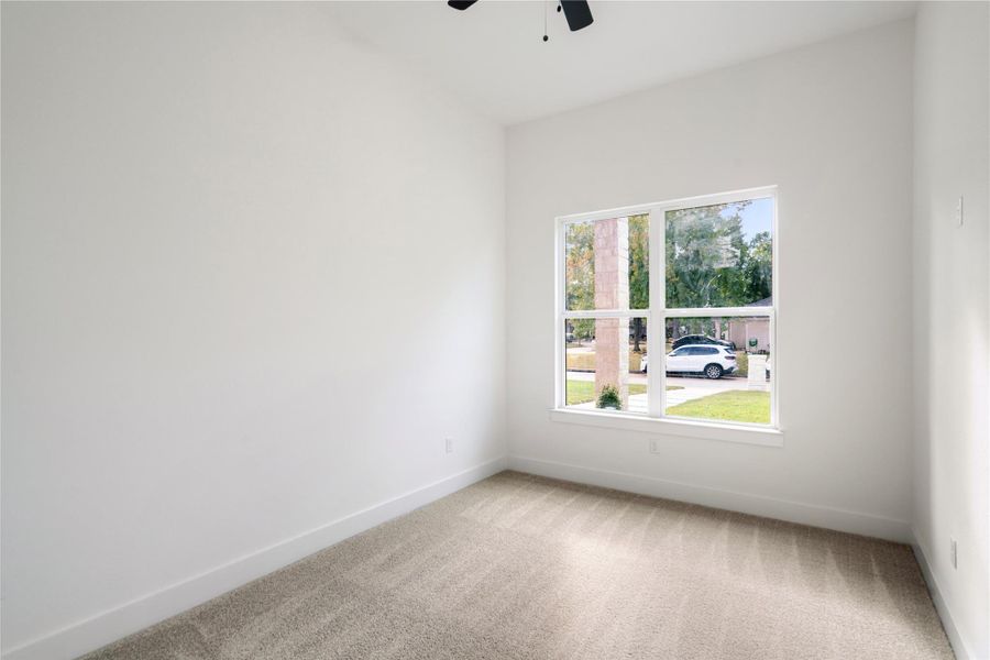 Bright and inviting, this bedroom features ample natural light and plush carpeting, creating a cozy retreat.