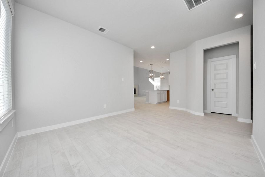 Craft enduring memories with loved ones around the table! This roomy dining area boasts stylish flooring, personalized paint, and is conveniently situated next to the family room and kitchen, fostering an open and inclusive ambiance. Sample photo of completed home with similar floor plan. Actual colors and selections may vary. Craft enduring memories with loved ones around the table! This roomy dining area boasts stylish flooring, personalized paint, and is conveniently situated next to the family room and kitchen, fostering an open and inclusive ambiance. Sample photo of completed home with similar floor plan. Actual colors and selections may vary.