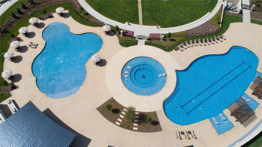 Expansive aquatic amenity featuring multiple pools, a circular spa, and surrounding hardscaping