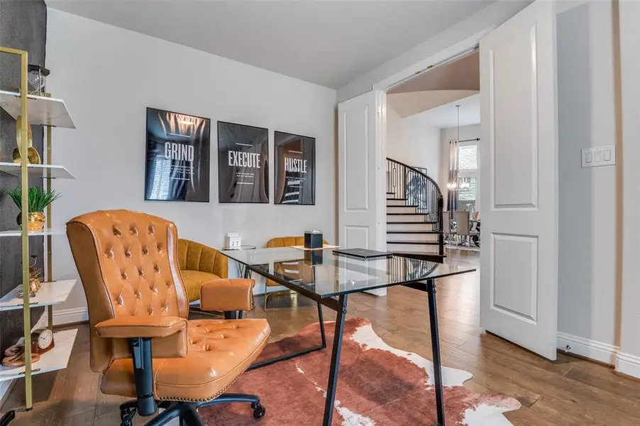 Office space with wood-type flooring and a chandelier