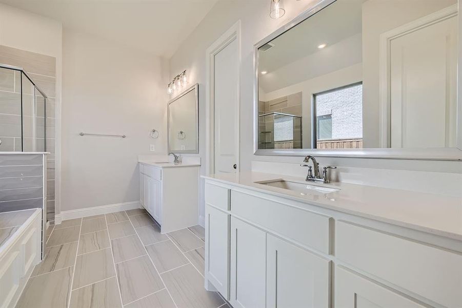 Bathroom featuring walk in shower and vanity