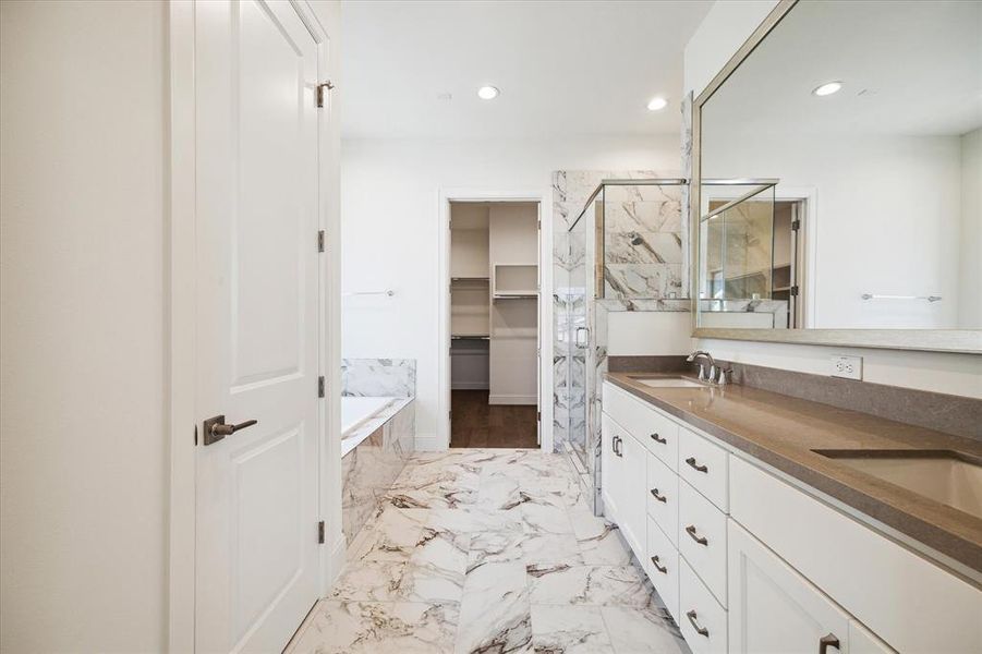 Primary bathroom retreat on the 3rd level offers a tranquil setting with a separate tub/shower.