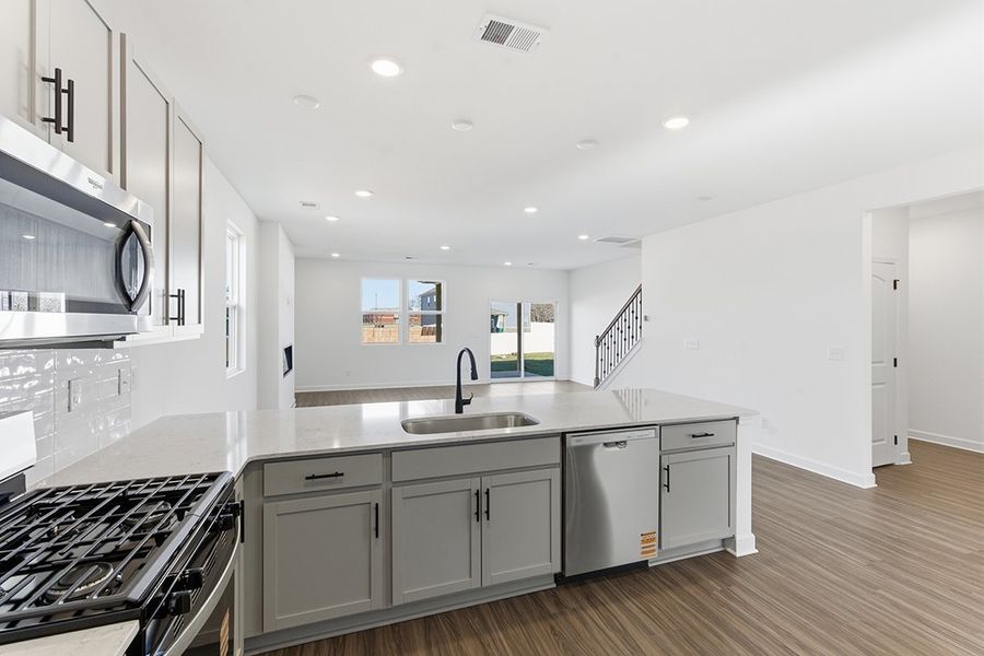 A kitchen with white cabinets.