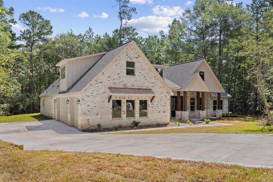 Front exterior of a new home in , New Waverly, TX, highlighting curb appeal (Image 21). Front exterior of a new home in , New Waverly, TX, highlighting curb appeal (Image 21).