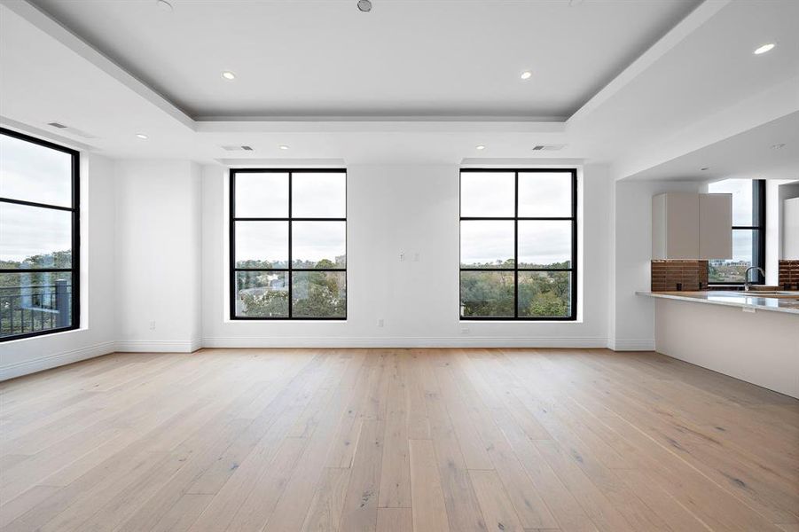 The open layout between the living area and the kitchen fosters in inclusive environment