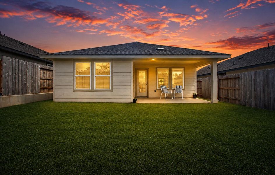 Stunning twilight view of the back exterior of the home. Stunning twilight view of the back exterior of the home.