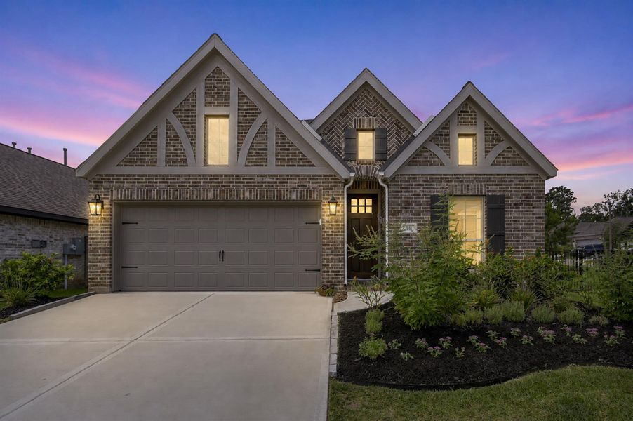Front exterior of a new home in The Woodlands Hills, Willis, TX, highlighting curb appeal (Image 26).