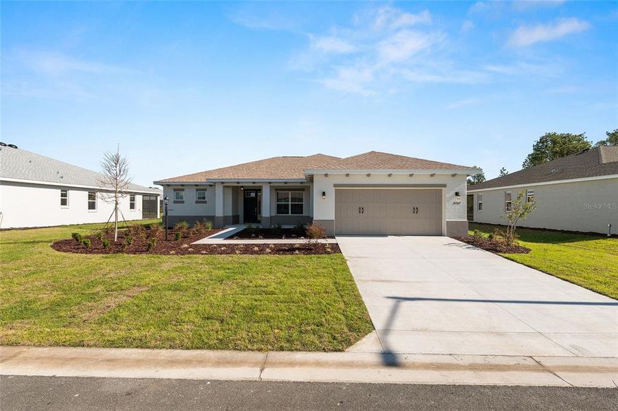 Front exterior of a new home in , Ocala, FL, highlighting curb appeal (Image 27).