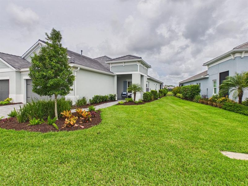 Front exterior of a new home in , Sarasota, FL, highlighting curb appeal (Image 27). Front exterior of a new home in , Sarasota, FL, highlighting curb appeal (Image 27).