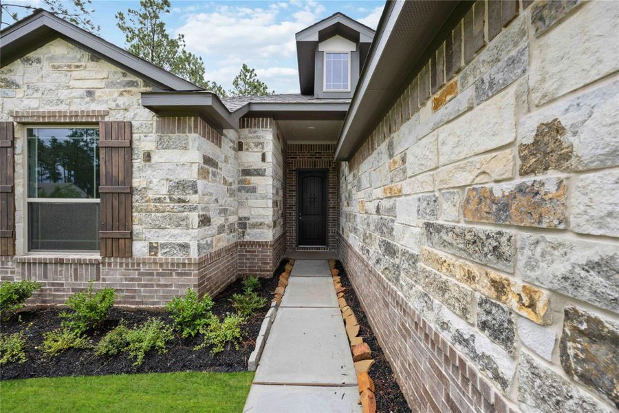 Front exterior of a new home in Deer Pines, Conroe, TX, highlighting curb appeal (Image 2).