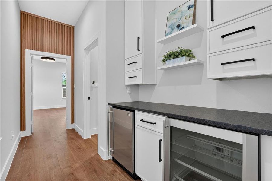 Hallway featuring wood-finish flooring and a decorative slat wall accent