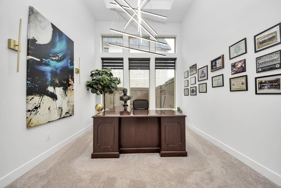 Private downstairs study with large windows and modern lighting.