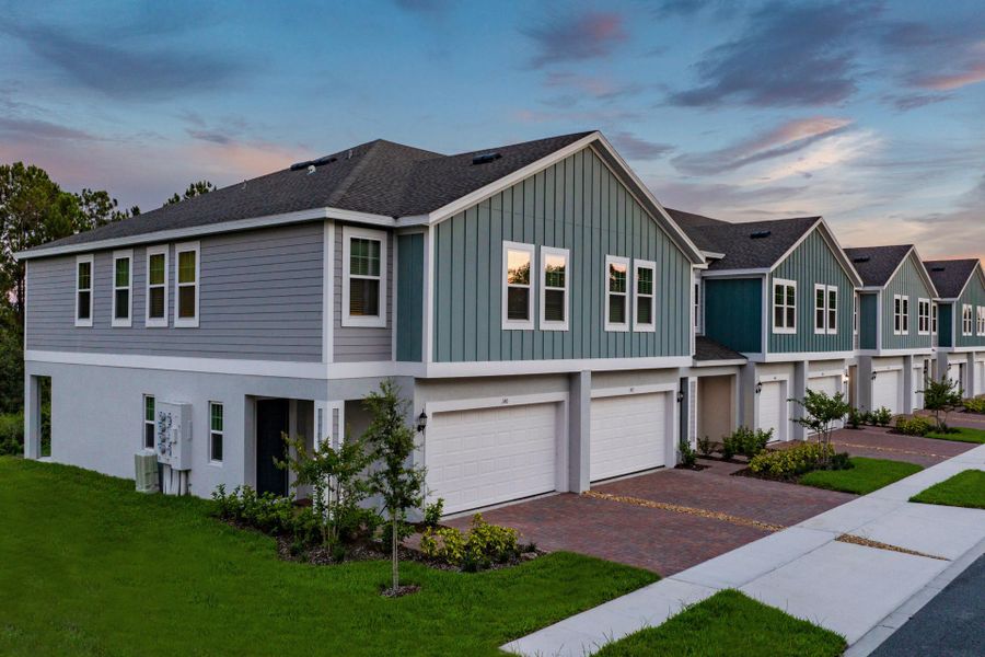Front exterior of a new home in Blue Springs Reserve Townhomes, Groveland, FL, highlighting curb appeal (Image 10).