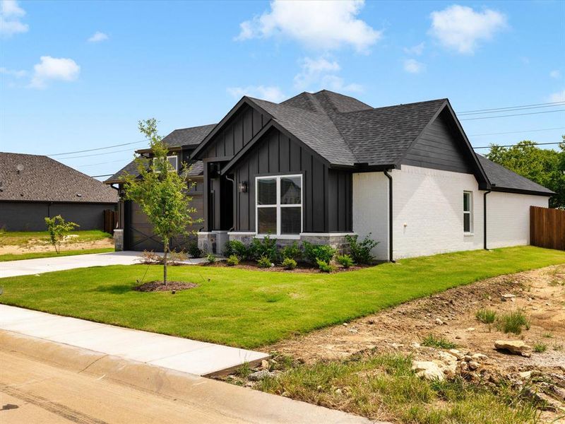 Front exterior of a new home in Hadley Farms, Godley, TX, highlighting curb appeal (Image 2). Front exterior of a new home in Hadley Farms, Godley, TX, highlighting curb appeal (Image 2).