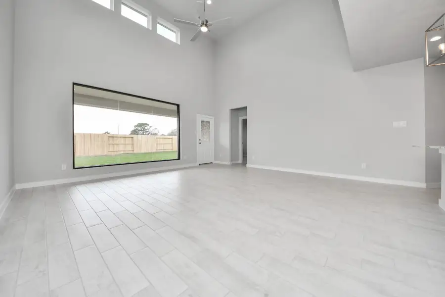 Take another glimpse into the heart of the home with this additional view of the family room—a sprawling space ready to accommodate all your gatherings. Sample photo of completed home with similar floor plan. Actual colors and selections may vary.