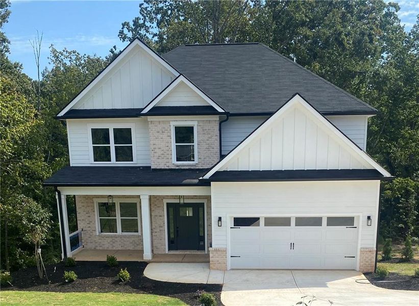 Front exterior of a new home in , Flowery Branch, GA, highlighting curb appeal (Image 1).