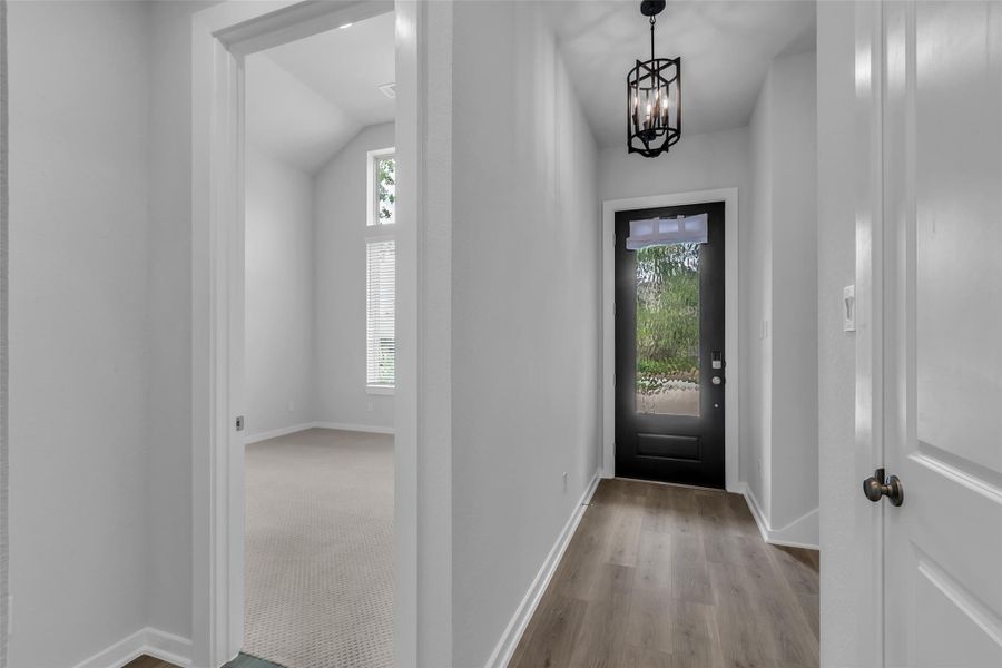 Inviting foyer with 8' mahogany front door.