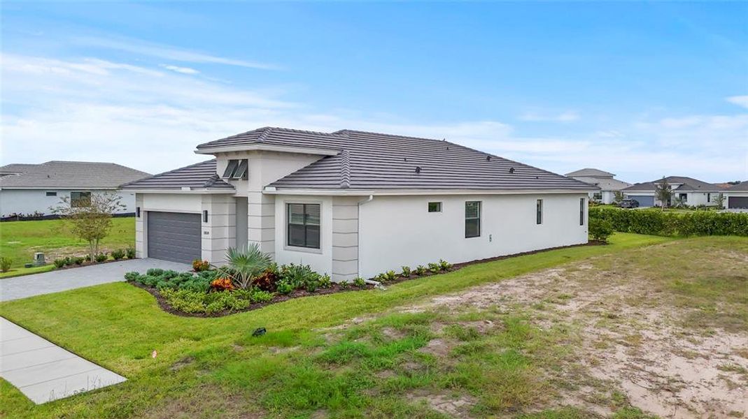 Front exterior of a new home in Cresswind Lakewood Ranch, Lakewood Ranch, FL, highlighting curb appeal (Image 26). Front exterior of a new home in Cresswind Lakewood Ranch, Lakewood Ranch, FL, highlighting curb appeal (Image 26).