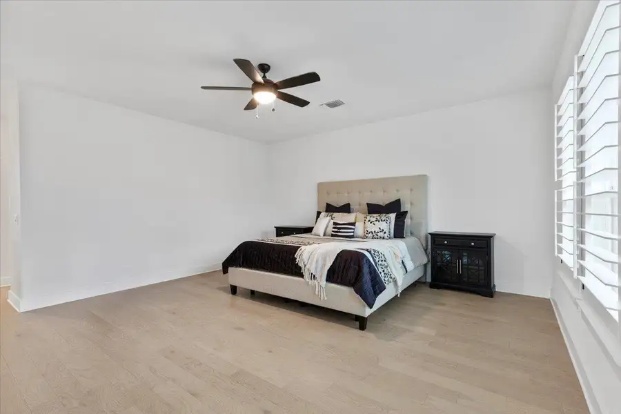 Bedroom featuring light wood-style floors and ceiling fan
