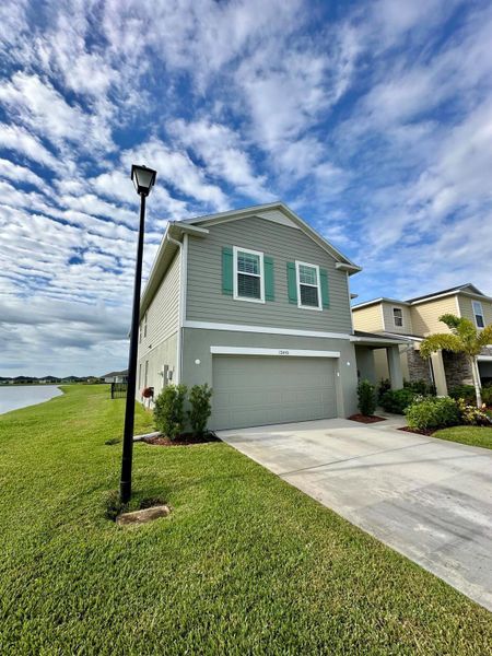 Front exterior of a new home in , Port St. Lucie, FL, highlighting curb appeal (Image 20).