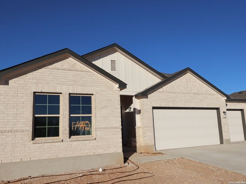 Front exterior of a new home in Hickory Ridge, Elmendorf, TX, highlighting curb appeal (Image 19). Front exterior of a new home in Hickory Ridge, Elmendorf, TX, highlighting curb appeal (Image 19).