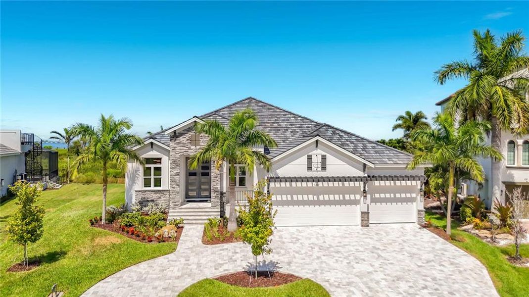 Front exterior of a new home in Legends Bay, Bradenton, FL, highlighting curb appeal (Image 23). Front exterior of a new home in Legends Bay, Bradenton, FL, highlighting curb appeal (Image 23).
