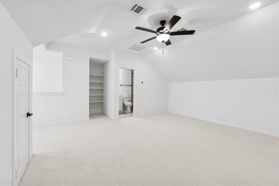 Additional living space with lofted ceiling, light carpet, ceiling fan, and recessed lighting Additional living space with lofted ceiling, light carpet, ceiling fan, and recessed lighting